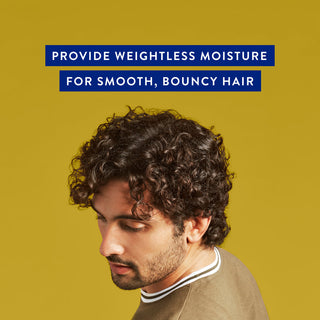 Man with short curly hair and text reading “Provide weightless moisture for smooth, bouncy hair”