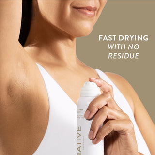 Person applying Native deodorant spray under arm with text reading fast drying with no residue