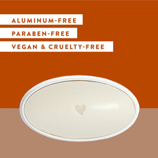 Inside of Native Black Oak & Amber deodorant laid flat on orange  background