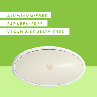 Inside of Native Cucumber & Mint deodorant laid flat on a green background