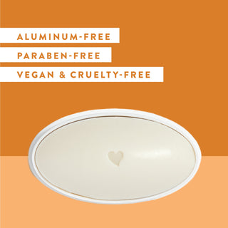 Inside of Native Mango & Orange Blossom deodorant laid flat on orange background