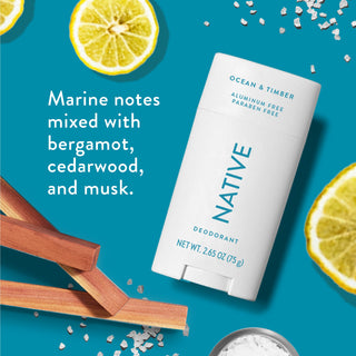 Native deodorant with text saying "Marine notes mixed with bergamot, cedarwood, and musk", styled with bergamot slices