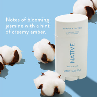 Native deodorant with text saying "Notes of blooming jasmine with a hint of creamy amber", styled with cotton flowers