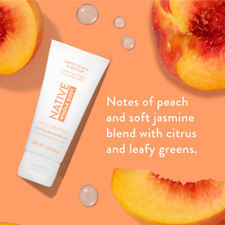 Flat-lay of Native Whole Body Deodorant with peach slices on peach background