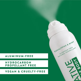 Angled view of Native Whole Body Deodorant in Eucalyptus & Mint scent spraying, labeled aluminum-free and natural propellant