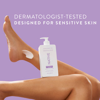 Native Lilac & White Tea Moisturizing Lotion bottle on a person’s legs, promoting “Dermatologist-Tested designed for sensitive skin”