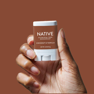 Hand holding Native Coconut & Vanilla Deodorant Stick 0.35 oz version