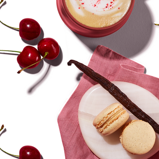 Cookies on quartz stone, styled with vanilla pods, cherries, and a coffee beverage