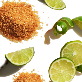 Pile of brown sugar next to lemon slices and  thin lemon peel