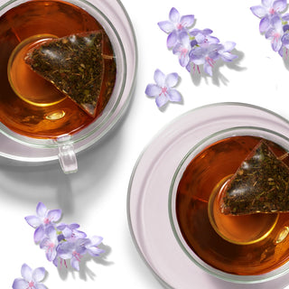 Two white tea beverages arranged with flowers