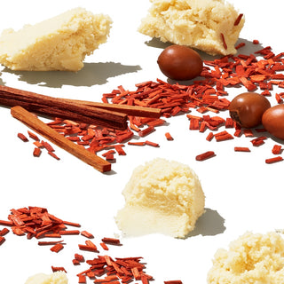 Arrangement of shea butter, sandalwood sticks and dried fruit