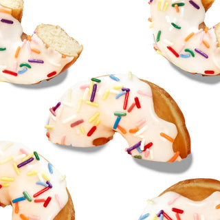 Sprinkled donuts sliced in half and arranged