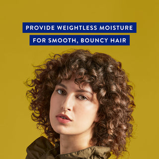 Woman with curly hair with text reading “Provide weightless moisture for smooth, bouncy hair"