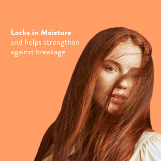 Woman with long red hair with text reading “Locks in moisture and helps strengthen against breakage”