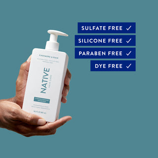 Hand holding Native Cashmere & Rain Strengthening Shampoo bottle with text reading “Sulfate free, silicone free, paraben free, dye free”