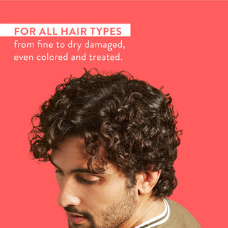 Man with curly hair and text reading “For all hair types from fine to dry damaged, even colored and treated”
