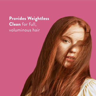 Woman with long red hair with text reading “Locks in moisture and helps strengthen against breakage”