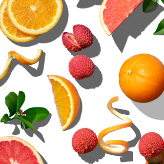 Arrangement of oranges, lychees, and delicate orange peel strips