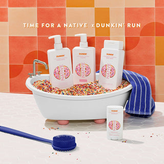 Native conditioner, shampoo, body wash, and deodorant in Dunkin - Strawberry Frosted scent with text reading "Time for a native x Dunkin' run"