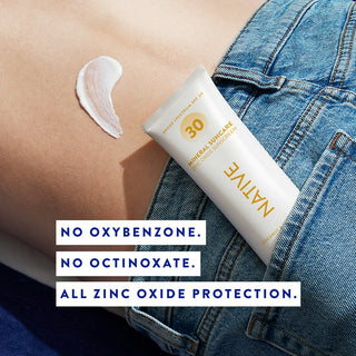 Tube of Native Mineral Suncare Daily Body Sunscreen SPF 30 in a jeans pocket with a swatch of sunscreen on the person's back