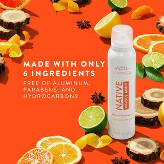 Native Whole Body Deodorant with lemon, oranges slices and wood pieces on orange background